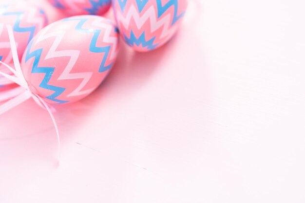 Painted Easter eggs on a pink background.