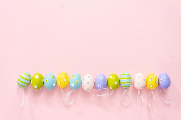 Painted Easter eggs on a pink background.