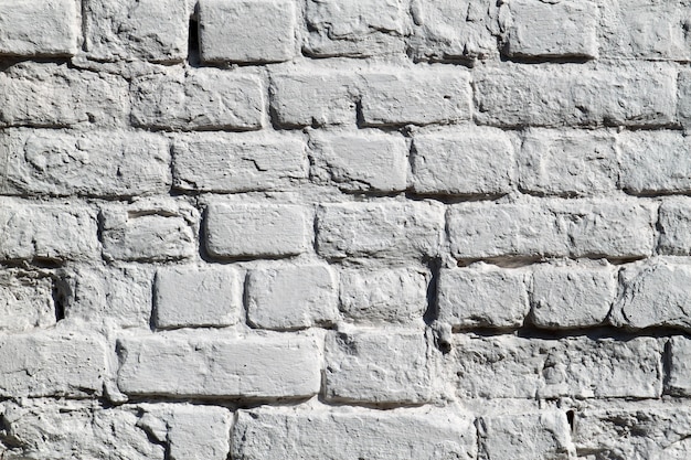 Photo the painted grey old brick wall