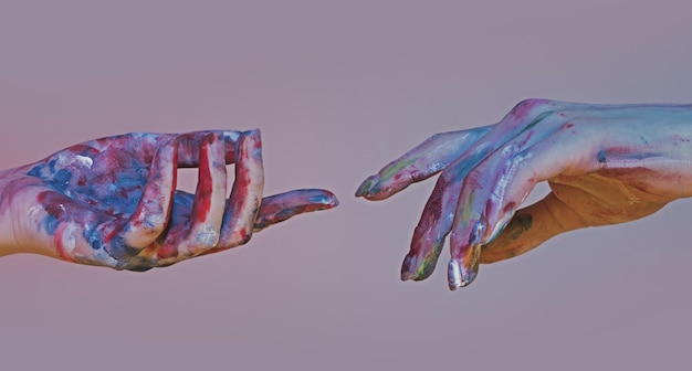 Painted hands reach hand hopeful concept two hands trying to touch adam sign human relation