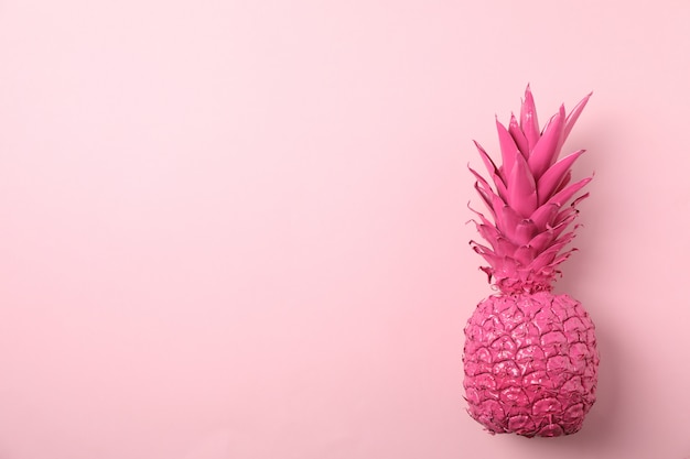 Photo painted pink pineapple on color background