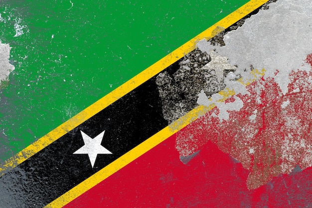 Painted saint kitts and nevis flag on a distressed old concrete wall surface