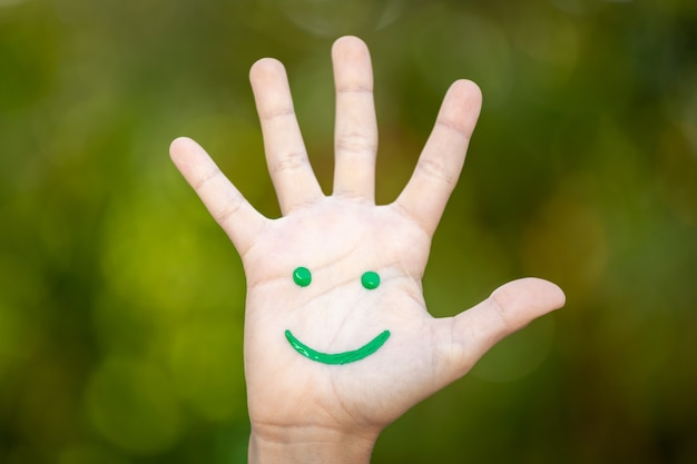 Painted smiley face on the palm