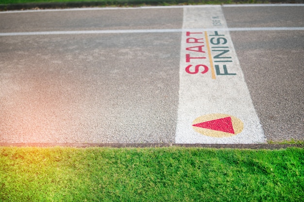 The painted start or finish line across the track at the park