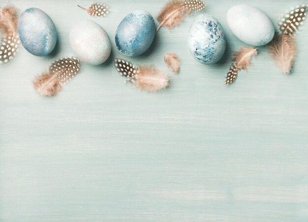 Painted traditional eggs for Easter holiday over light blue background