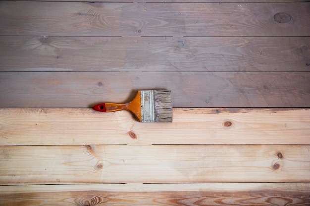 Painted wooden floor with grey colour and a brush on the floor