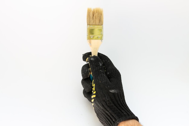 Painter brush in hand on a white background