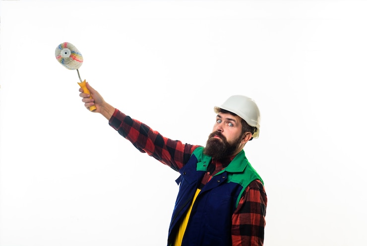  Painter handsome bearded worker with paint roller and hard hat repair building concept repairman