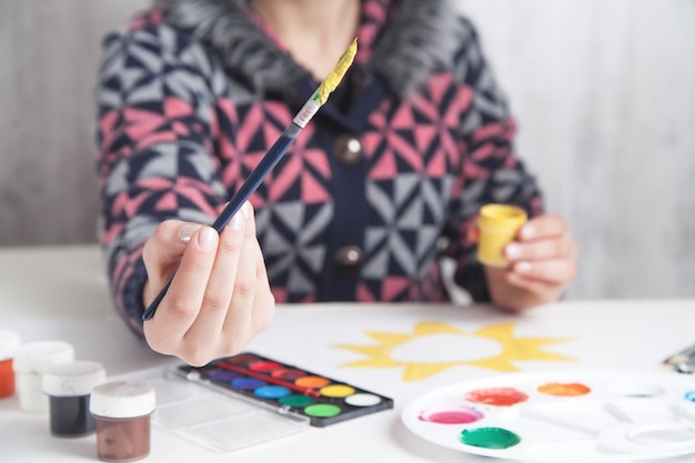 Painter holding brush and paint. Hobby