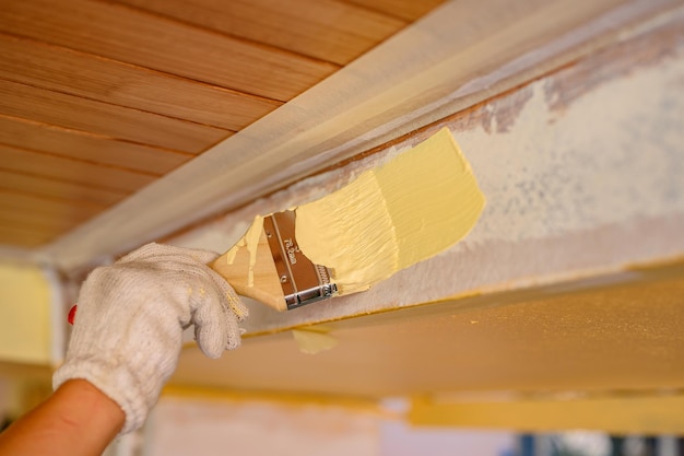 Painter man painting exterior wall for house improvement when lock down during Covid-19. Man in work and lifestyle.