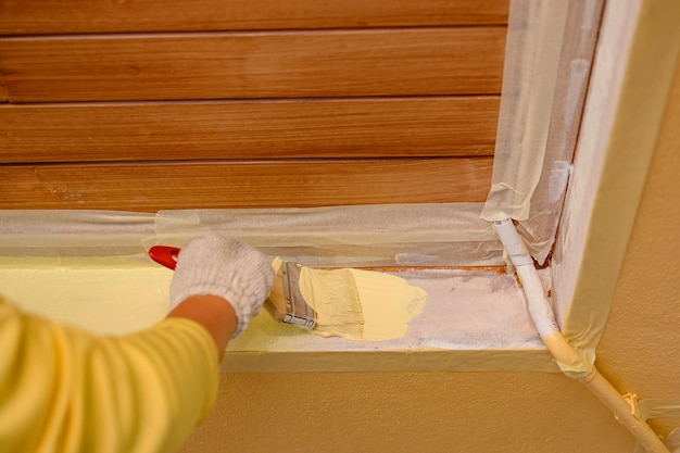 Painter man painting exterior wall for house improvement when
lock down during covid-19. man in work and lifestyle.