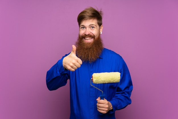 Painter man with long beard giving a thumbs up gesture