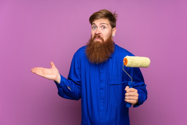Painter man with long beard having doubts with confuse face expression