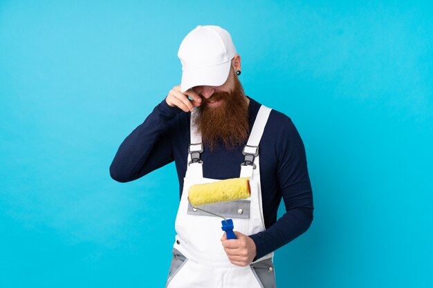 Painter man with long beard over isolated blue laughing