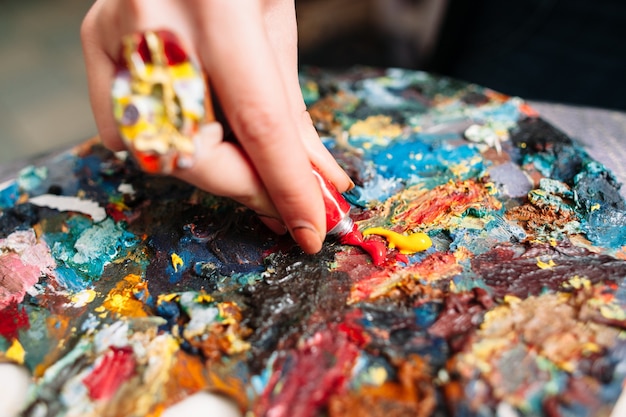 Painter mixing paints on palette