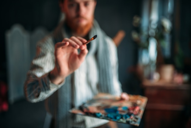 Painter with palette and brush in hand