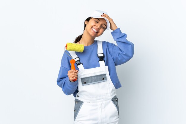 Painter woman over isolated white background smiling a lot