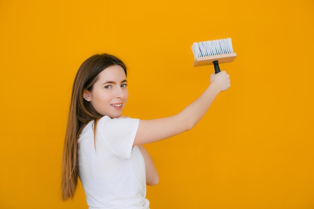 Painter women at work with roller painting wall painter house concept