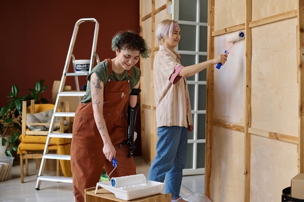 Photo painters painting walls in the room