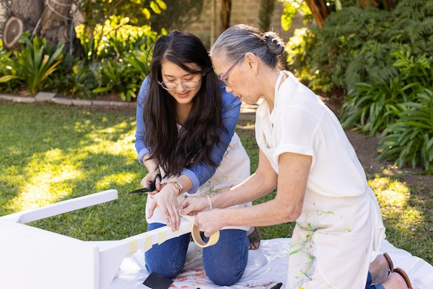 Photo painting and assembling furniture asian granddaughter and grandmother bonding in diy project