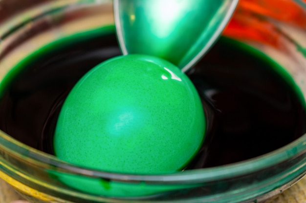 Painting, dying green eggs for Easter