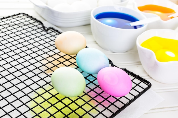 Painting eggs in pastel colors for Easter.