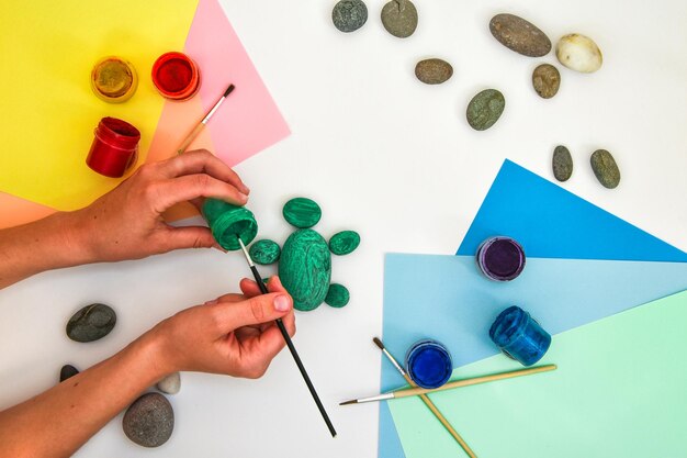 Painting a rock green turtle on a stone step by step children art project diy concept step by ste