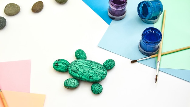 Painting a stone green turtle on a stone step by step