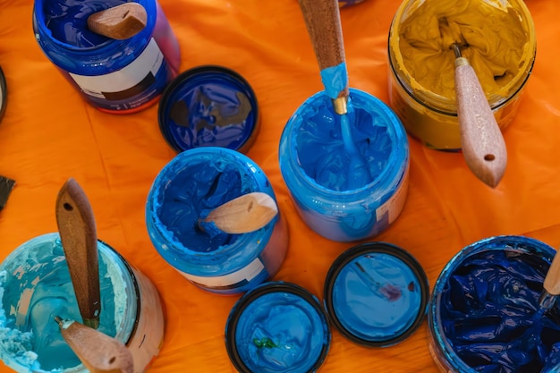 Paints brushes jars on the table