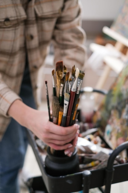 Paintsplattered brushes close up with oil paint in the art studio