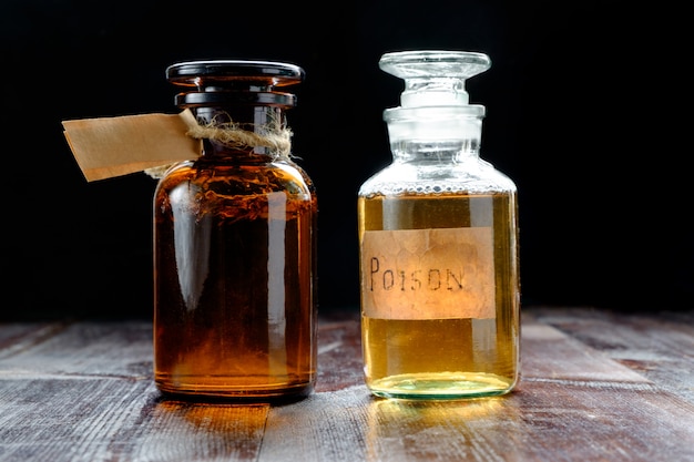 Photo pair of apothecary bottles with potion of poison or tincture