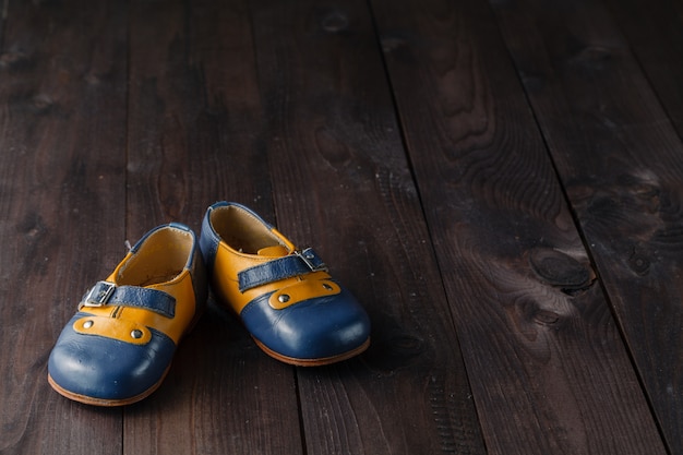 Pair of baby shoes on wooden table