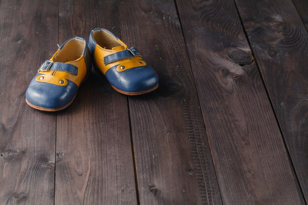 Pair of baby shoes on wooden table