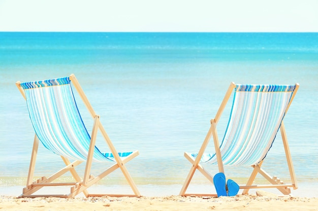 Pair of beach chairs at sea shore Vacation concept