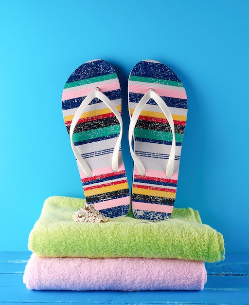 Pair of beach slippers and towels