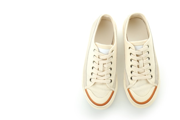 Pair of beige sneakers isolated on white background