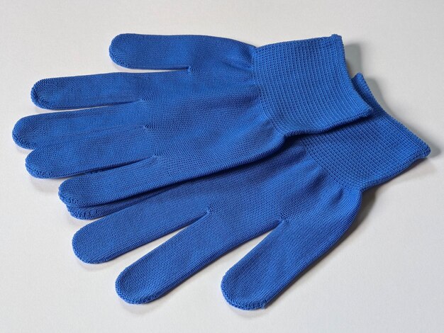 A pair of blue gloves on isolated background