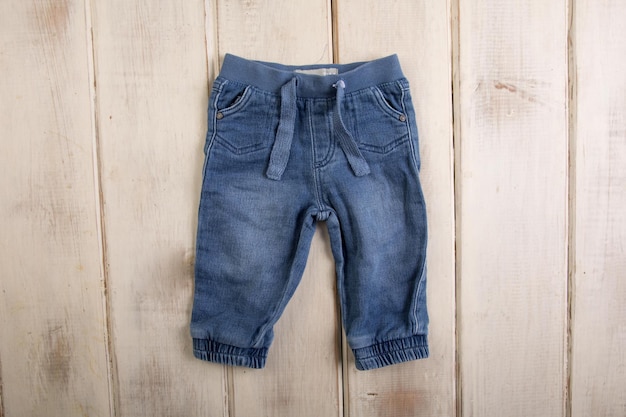 A pair of blue jeans with the word baby on the front.