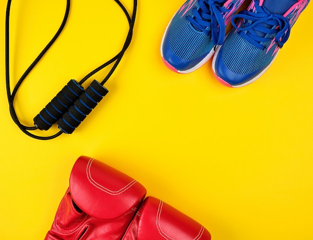 Pair of blue sneakers, red leather boxing gloves 