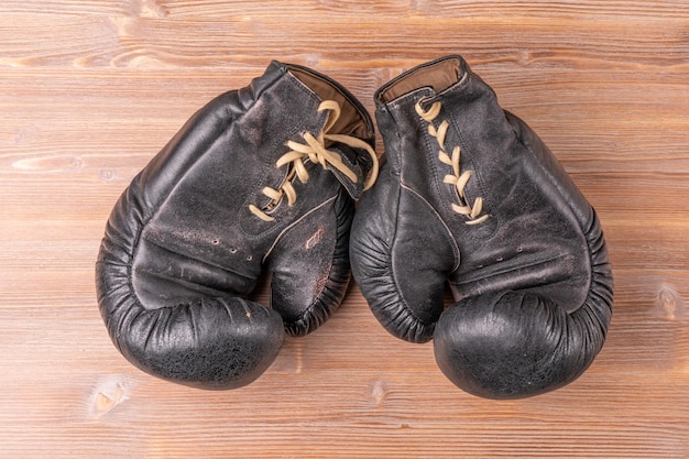 A pair of boxing gloves with the laces on the bottom of them