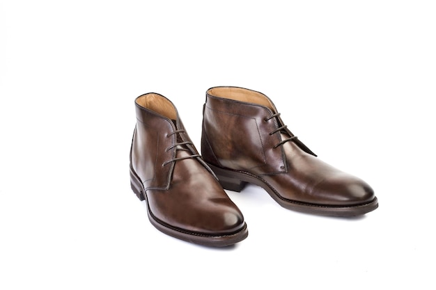 A pair of brown boots isolated on a white background in a top view