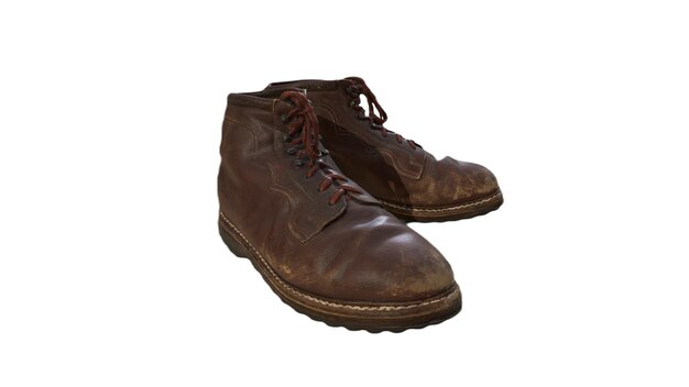 A pair of brown boots with the word " the word " on the bottom.