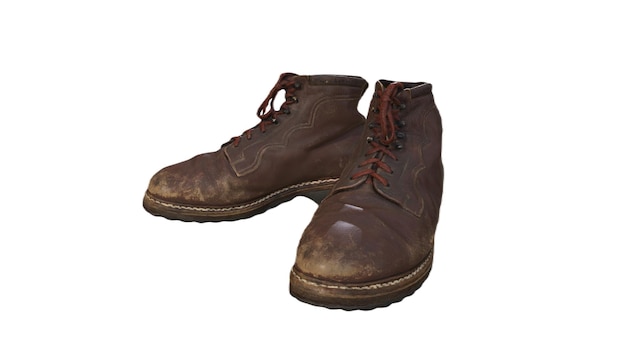 A pair of brown boots with the word " the word " on the bottom.