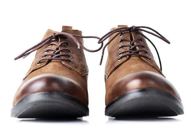 Pair of brown leather womens boots on white background isolated