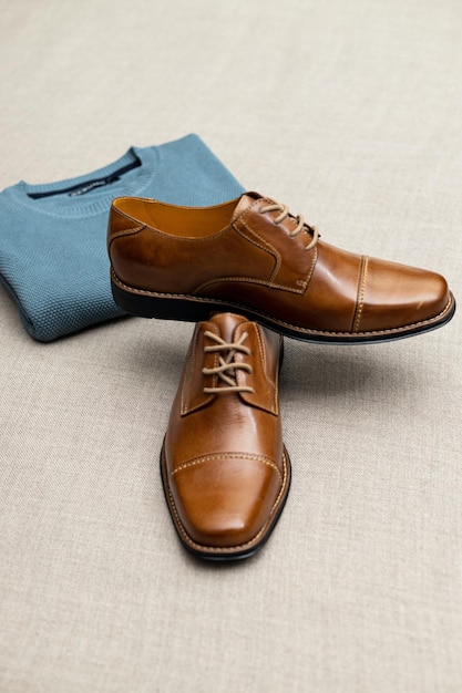 A pair of brown shoes with a blue sweater and a blue sweater.