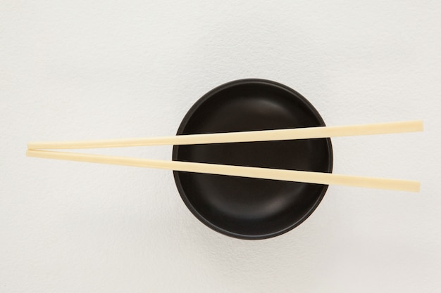 Pair of chopsticks over a bowl