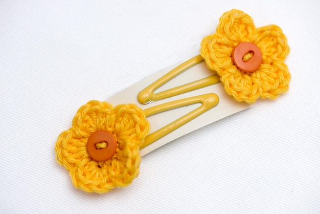 A pair of clasp woven flower hair clips