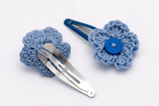 A pair of clasp woven flower hair clips