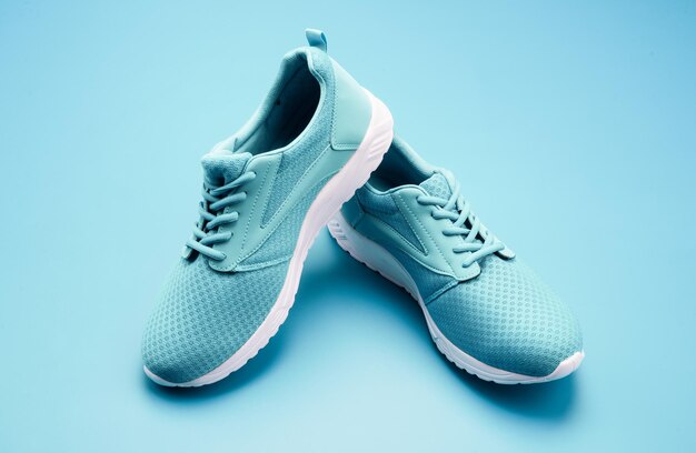 Pair of comfortable sport shoes sporty blue sneakers shoes on blue background