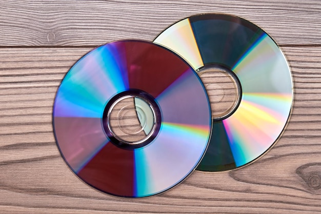 Pair of compact discs on a wooden background